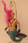 Robbie was the first feathered merman I saw from December Diamonds. I think he is a great companion piece for Jonathan. They make the Mardi Gras scene.  I love his colors the best of all my feathered mermen and mermaids. Take a look at his tail and fins. A nice color transition.
I have been told by a source that Jonathan, Robbie, and Wave mermen were not Mardi Gras themed, but in fact were supposed to be Las Vegas show guys hence the feather boas. I inquired at December Diamonds about Jonathan and was told he was Mardi Gras themed. Either way, you make the decision.  All three are great merman and now very rare. 
