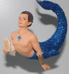 Ocean was a merman that caught the eye because of his twisting upward swimming pose. I love the mermen holding the shells, and he is holding one. I love the blue fish on his necklace, too. a great merman!