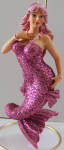 Joanie is the mermaid that was a limited edition. There were reportedly 3000 made and shipped to commemorate Breast Cancer Awareness which one of the owners of December Diamonds' mother succumbed to. Proceeds went to help research this disease. Note how beautiful this mermaid is. The tail in a twist makes this extra beautiful and classy. 
